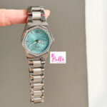 Montre Scottie - bleu turquoise et bande argentée (+ boîte + sac + ajusteur de bande)