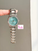 Montre Scottie - bleu turquoise et bande argentée (+ boîte + sac + ajusteur de bande)